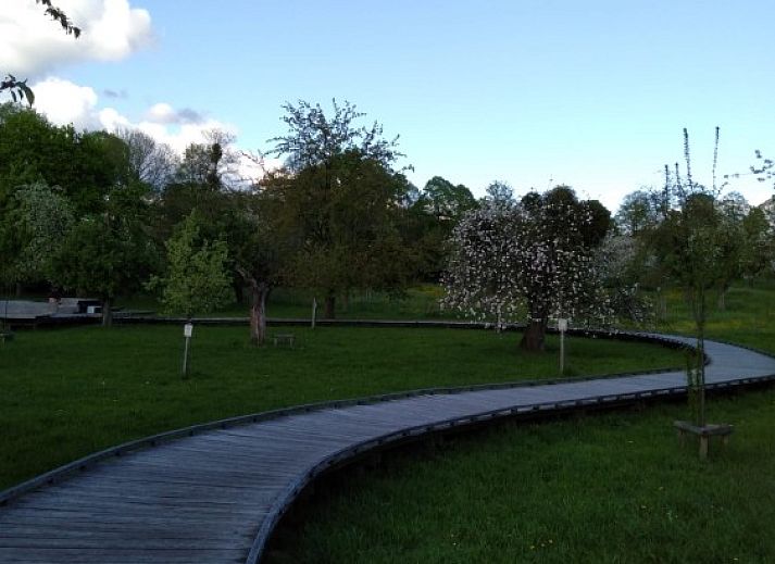 Cozy bedroom at De Lodge, a bed and breakfast in Grote-Spouwen, Limburg, overlooking the evening sky.