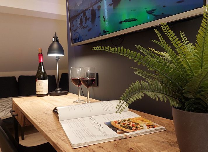 Entrance to B&B Viator Tongeren in Limburg, Belgium with green decoration and warm lighting.