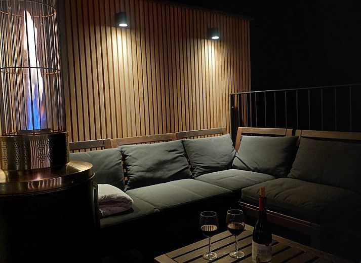 Entrance to B&B Viator Tongeren in Limburg, Belgium with green decoration and warm lighting.