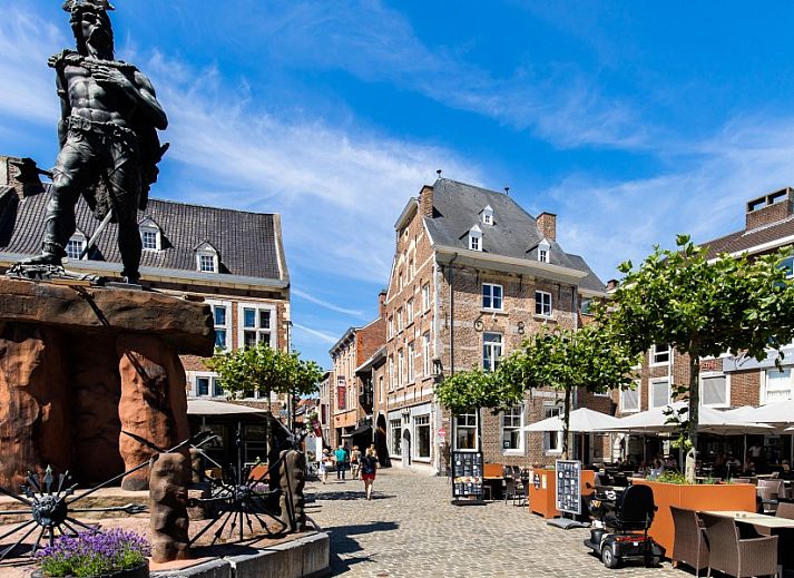 Outdoor lounge with heater at B&B Viator Tongeren in Belgium, ideal for evening relaxation.