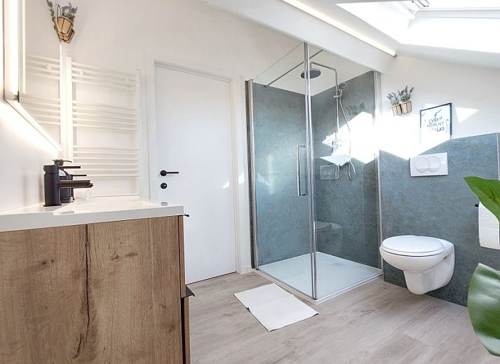 Outdoor lounge with heater at B&B Viator Tongeren in Belgium, ideal for evening relaxation.