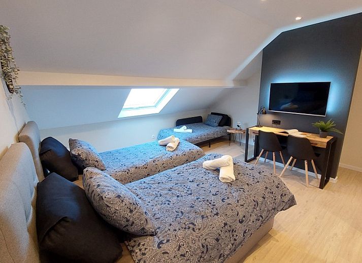 Outdoor lounge with heater at B&B Viator Tongeren in Belgium, ideal for evening relaxation.