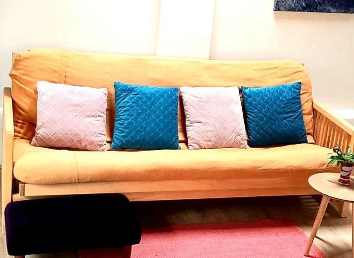 Gezellige binnenruimte van Stay with the artist B&B in Teuven, Limburg, met kunstwerken en houten plafond.