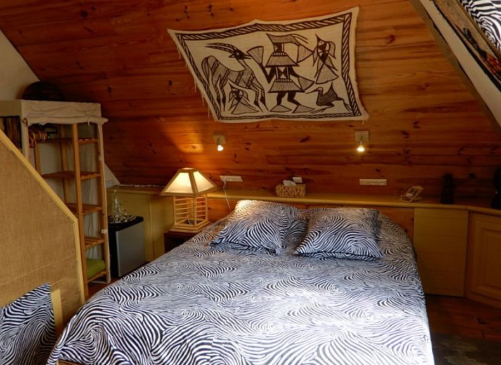 Comfortable bedroom in Charlatan bed and breakfast Knokke-Heist, Belgian coast, with warm decor.