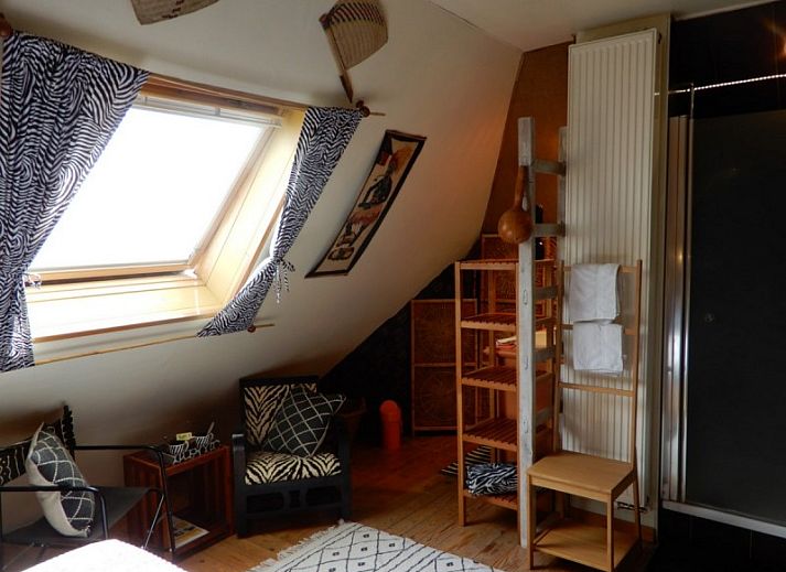 Comfortable bedroom in Charlatan bed and breakfast Knokke-Heist, Belgian coast, with warm decor.