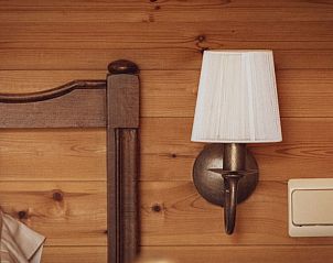 Sfeervolle wandlamp in een slaapkamer van Landgoed Argiliere, bed and breakfast in Poperinge.