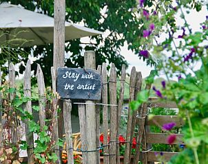 Rustieke tuinomheining bij Stay with the artist bed and breakfast in Teuven, Limburg, omgeven door groene natuur.